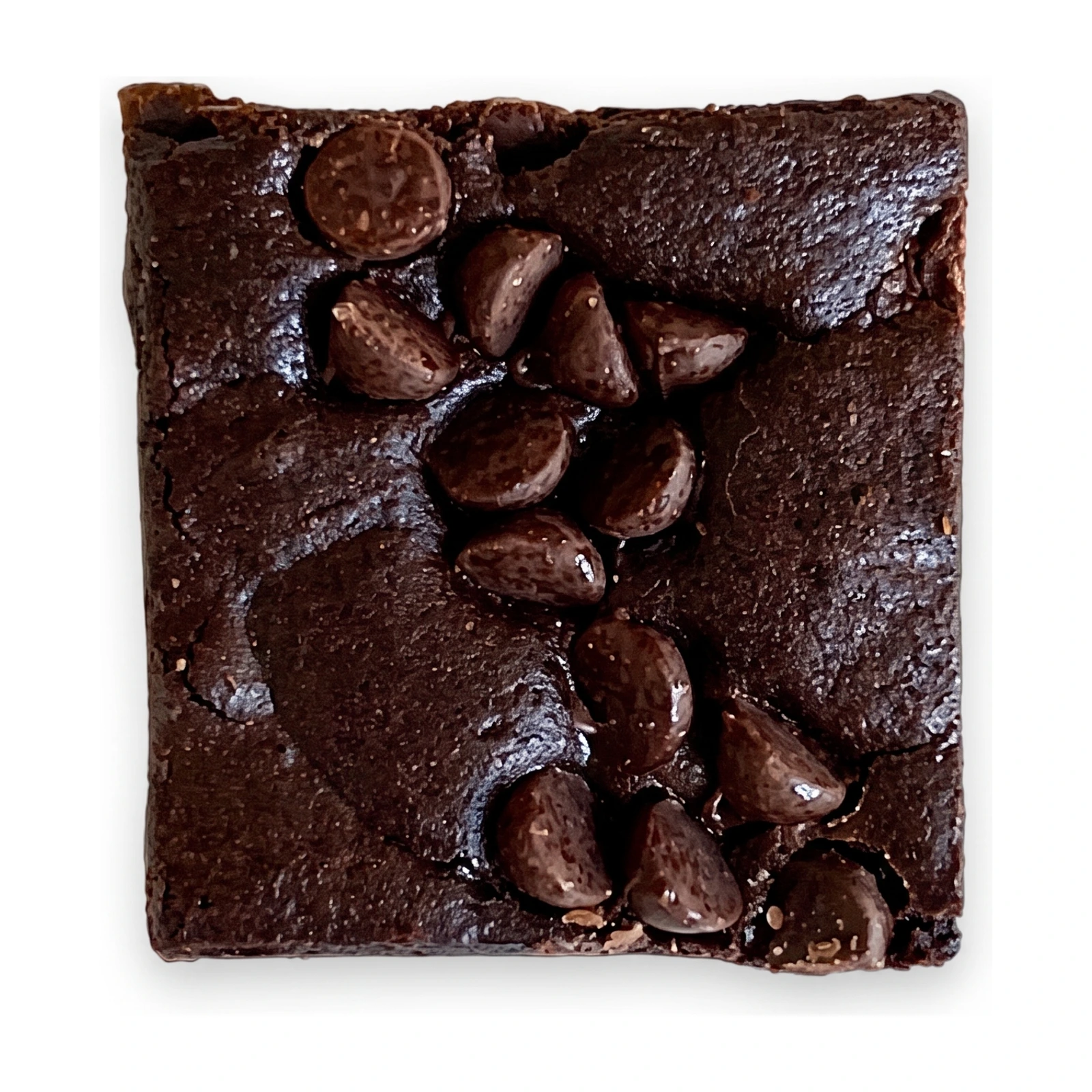 Two Double Dark brownies stacked on a dark plate, tops studded with chocolate chips
